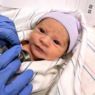 Newborn baby getting checked out by the doctor